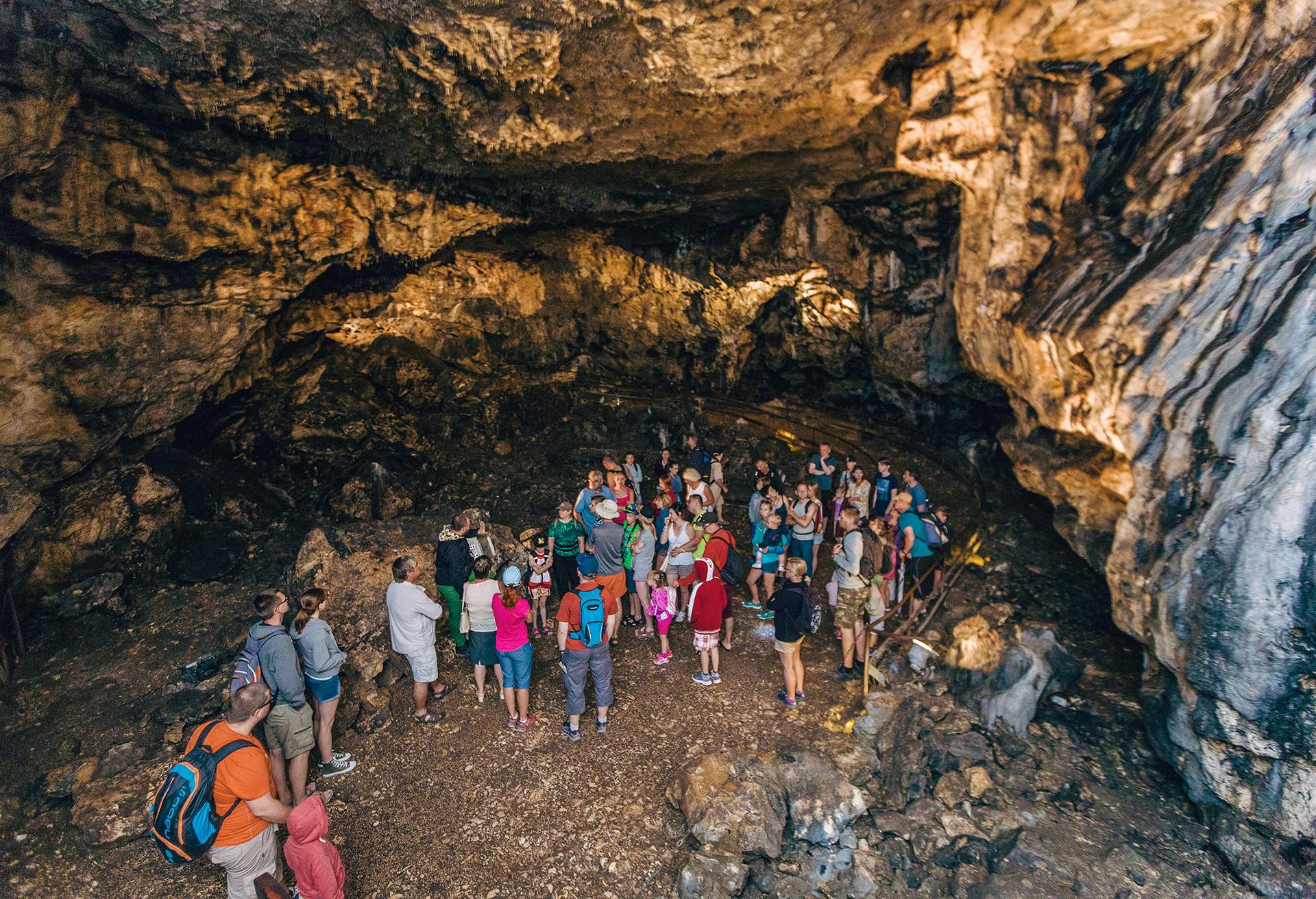 Group of people standing in a cave in Ojców National Park, Poland