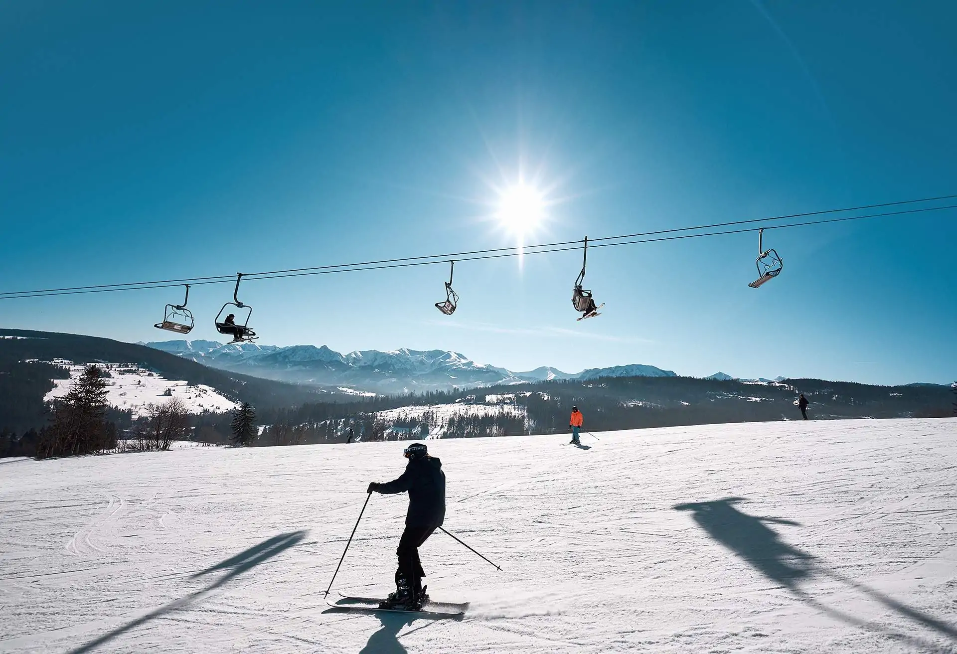 Man on ski slopes on a sunny day, Malopolska, Poland